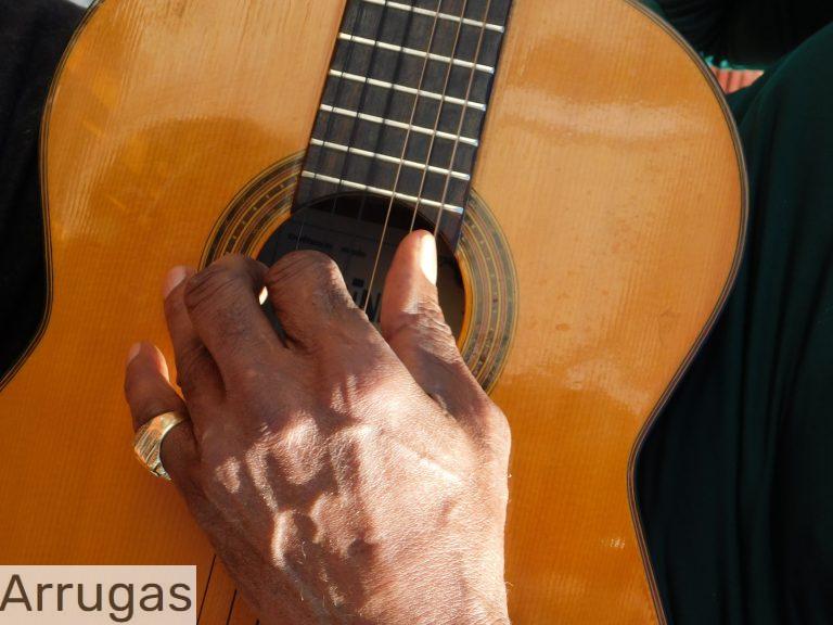 a close up of a person playing a guitar