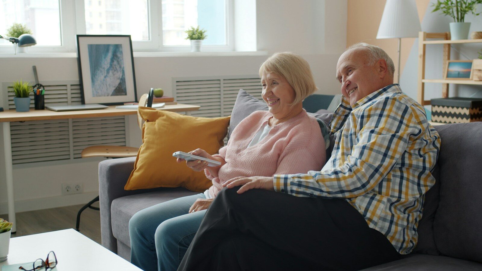Pareja mayor viendo la televisión en casa